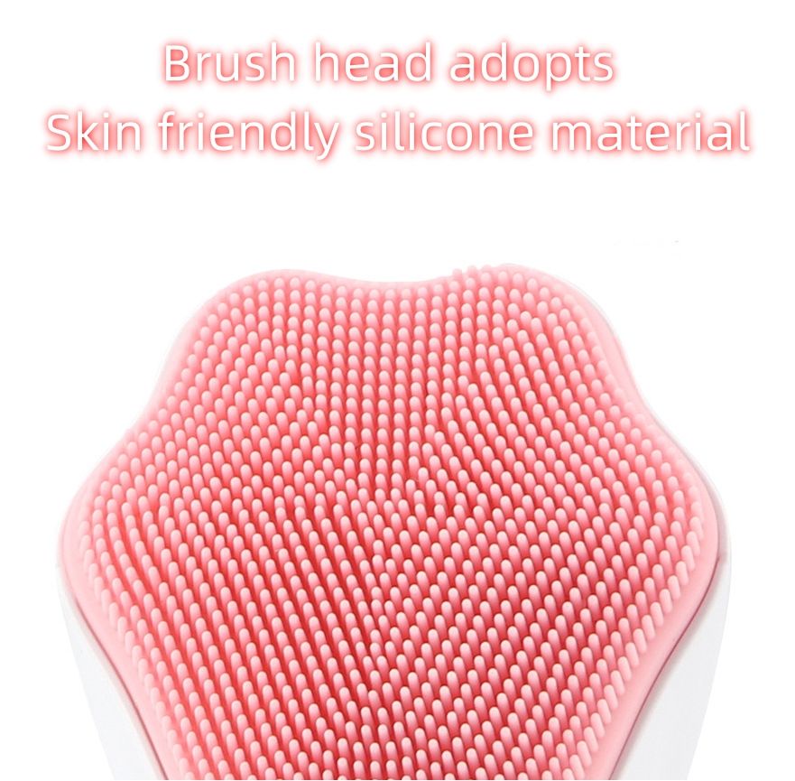 Close-up of the brush head on a pink handheld silicone face scrubber exfoliator