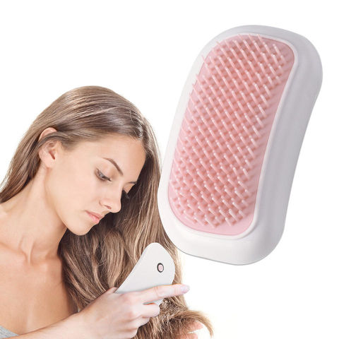 Girl brushing her hair with an Electric Massage Comb