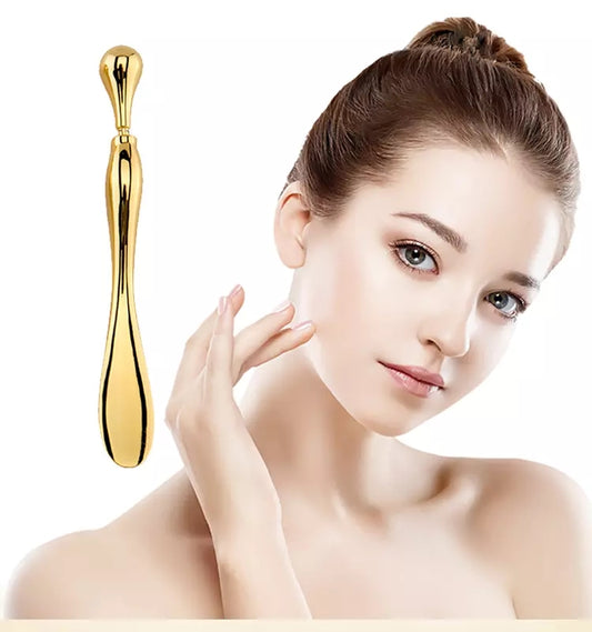 Gold Eye Cream Stick Roller next to a beautiful girl