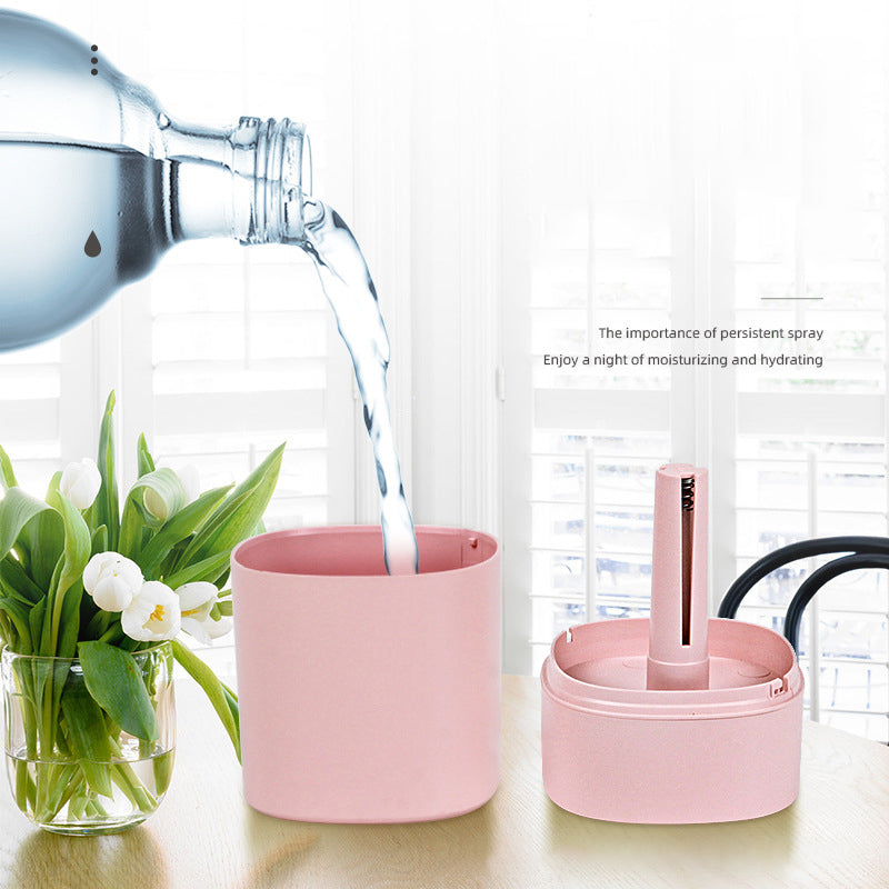 Pink USB Desktop Humidifier with LED Night Light being filled with water