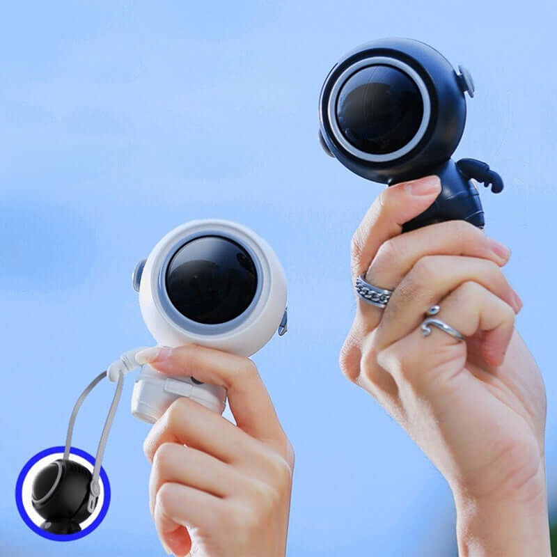 Two hands holding black and white Astronaut Portable Neck Fans