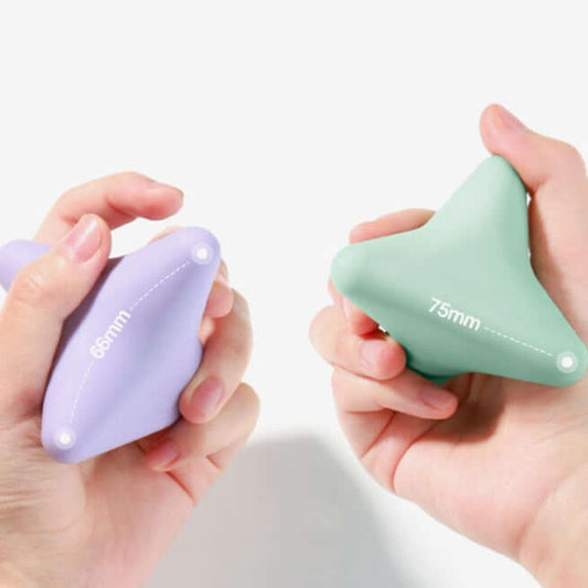 Two hands holding green and purple Astronaut Silicon Massage Cone